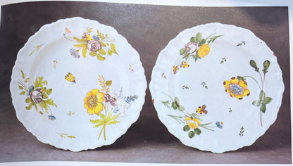 Yellow pitcher and tray with floral designs on a gray background